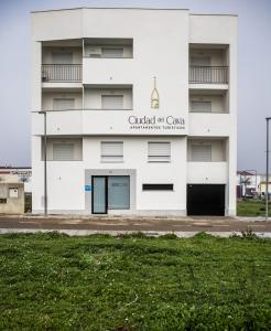 a white building with a church of canada sign on it at Apartamentos Ciudad del Cava in Almendralejo