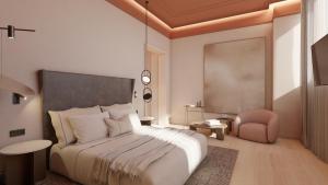 a bedroom with a large bed and a pink chair at Fahana Triana 54 Adults Only in Las Palmas de Gran Canaria