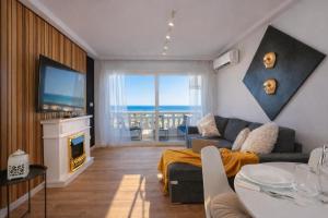 a living room with a couch and a tv and a fireplace at Amber Signature Apartment in Torrevieja