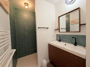 a bathroom with a sink and a mirror and a shower at Les Alizés, 3 étoiles in La Brée-les-Bains +17 photos