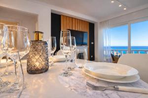 a table with wine glasses and a plate on it at Amber Signature Apartment in Torrevieja