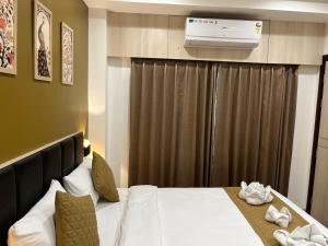a hotel room with a bed and a air conditioner at The Executive Inn in Siliguri