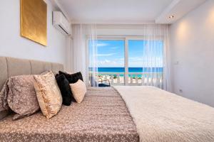a bedroom with a bed with a view of the ocean at Amber Signature Apartment in Torrevieja