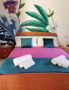 a bedroom with a bed with towels on it at B&B Romy House in Pianopoli