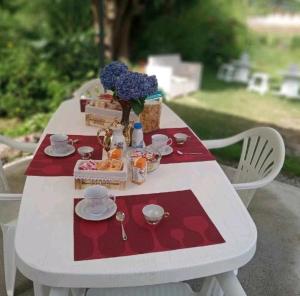 a white table with a tea set on it at B&B Romy House in Pianopoli
