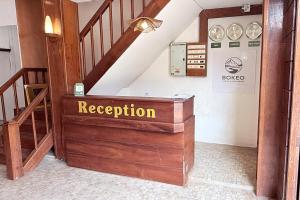 a staircase with a wooden box with the words reception at Bokeo Lodge & Restaurant in Ban Houayxay +21 photos