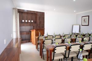 a room with a long table and chairs in it at Firwood Lodge in Pretoria