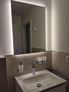 a bathroom with a sink and a large mirror at Haardblick in Flaesheim +21 photos