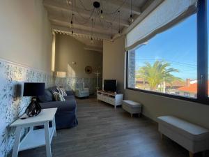 a living room with a couch and a large window at Casa Candida in Samaleo