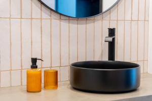 a sink with two bottles of soap on a counter at Essence Villas - Bath & Sunset in Ribeira Grande +12 photos