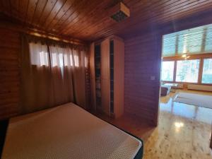 a bedroom with a bed in a room with a window at Narvijärven lomamökki in Rauma