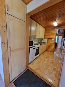 a small kitchen with a stove and a refrigerator at Narvijärven lomamökki in Rauma +14 photos