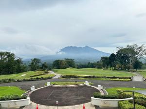 a view of a golf course with a green at Timber Sanctuary at Rancamaya in Ciawi Bogor