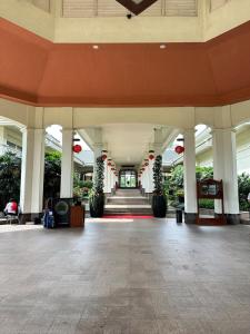 an empty lobby of a building with red decorations at Timber Sanctuary at Rancamaya in Ciawi Bogor +18 photos
