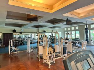 a gym with a lot of treadmills and machines at Timber Sanctuary at Rancamaya in Ciawi Bogor