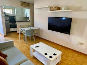 a living room with a couch and a table at Apartamentos Turísticos Yamasol in Fuengirola