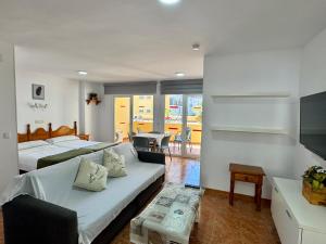 a living room with two beds and a couch at Apartamentos Turísticos Yamasol in Fuengirola +27 photos