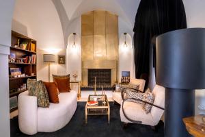 a living room with a couch and chairs and a fireplace at Riad Anaqa in Marrakesh