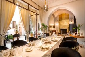 a dining room with a long table and chairs at Riad Anaqa in Marrakesh