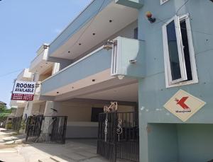 a blue building with a sign on the side of it at The K Inn Wavefront in Mahabalipuram