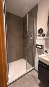 a shower with a glass door in a bathroom at Hotel Gästehaus Linden in Wolfenbüttel +72 photos