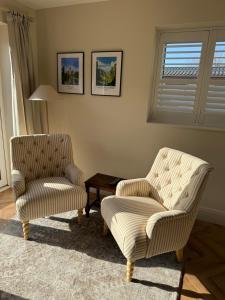 two chairs and a table in a living room at Lillypool Farm in Shipham