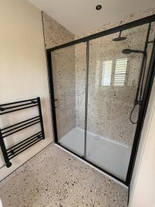 a shower with a glass door in a bathroom at Lillypool Farm in Shipham