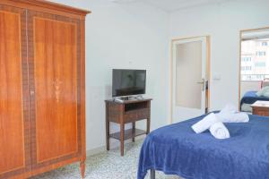 a bedroom with a bed and a tv on a table at Gest Short Rent Siena 4 in Siena +15 photos