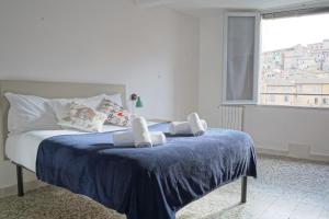 a bedroom with a bed with two towels on it at Gest Short Rent Siena 4 in Siena