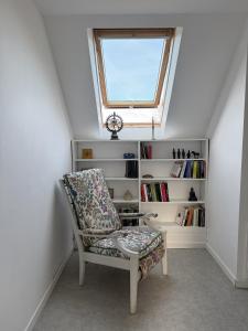 a room with a chair and a window at Maison Équilibre in Royère-de-Vassivière