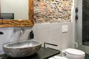 a bathroom with a large stone sink on a counter at Trilocale Luxury - 5 minuti Acquario di Genova in Genoa