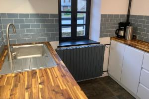 a kitchen with a sink and a window at Vacances au Lac de Saint-Pardoux in Compreignac +119 photos