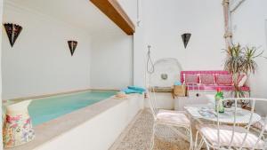 a room with a pool and a table and chairs at Lleo Eleven in Pollença