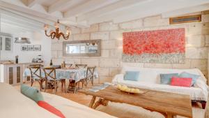 a living room with a couch and a table at Lleo Eleven in Pollença