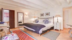 a bedroom with a large bed and a mirror at Lleo Eleven in Pollença +24 photos