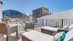 a patio with chairs and tables on a balcony at Lleo Eleven in Pollença