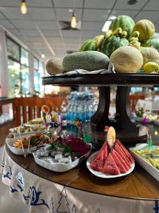 a buffet with plates of food on a table at HUMSON BULOQ SANATORIUM in Khumson