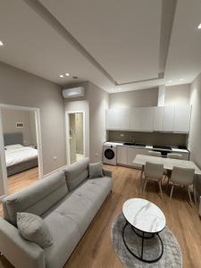 a living room with a couch and a table at Apartment 27 in Elbasan