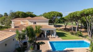 a house with a swimming pool in front of it at Casa Atlantico in Quinta do Lago