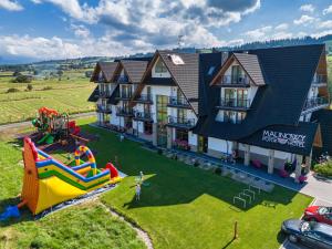 an aerial view of a house with a playground at Malinowy Potok in Białka Tatrzańska