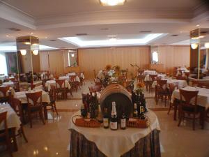 a restaurant with a table with wine bottles on it at Continental Palace in Psalidi