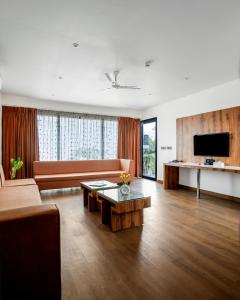 a living room with a couch and a table at Dallas Beach Resorts Ashvem Beach in Mandrem