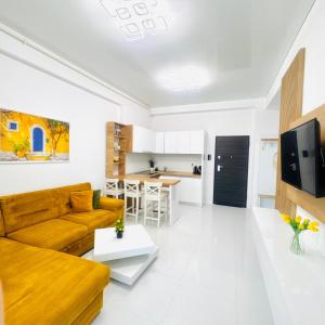 a living room with a couch and a table at Stefan Resort Mamaia Nord in Mamaia Sat/Năvodari