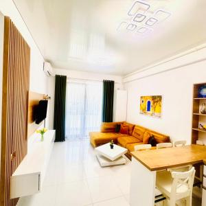 a living room with a couch and a table at Stefan Resort Mamaia Nord in Mamaia Sat/Năvodari