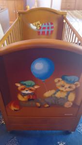 a wooden crib with stuffed animals in it at Vasiliki in Dhílesi
