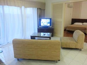 a living room with a couch and a television at A Famosa Resort Melaka in Melaka
