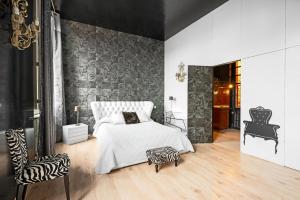 a bedroom with a white bed and a zebra print wall at La Rose des Vents Le Vigan - Hyper centre - Parking in Albi