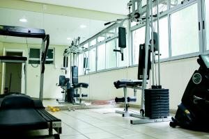 a hospital room with a gym with machines and mirrors at Steel Valley Hotel in Ipatinga