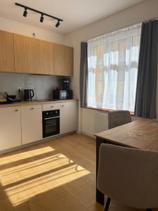 a kitchen with a table and a dining room at Odpocznij w Centrum in Wałbrzych +7 photos