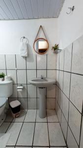 a white bathroom with a sink and a mirror at Casa da Silvana in Fernando de Noronha +34 photos
